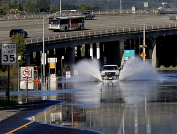 A truck drives through a flooded road in Sausalito.